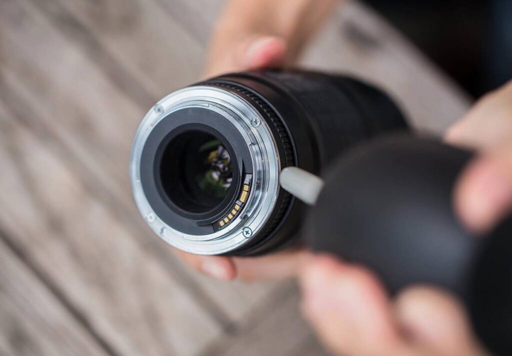 cleaning camera lens with air blower.